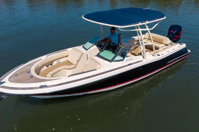 Slide: The Image of 2017 Chris-Craft Calypso 26 boat with canopy, cruising on calm water. - 8