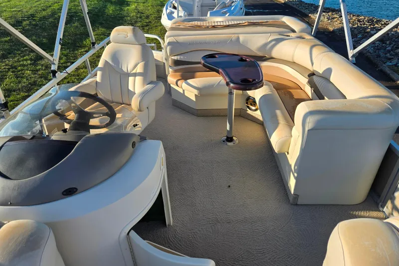 Slide: The Image of 2008 Bennington 2275RL pontoon boat interior with plush seating and steering console. - 12