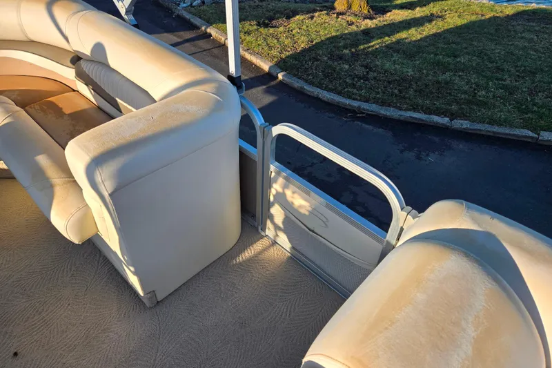 Slide: The Image of 2008 Bennington 2275RL boat interior with beige seating and open side gate. - 13