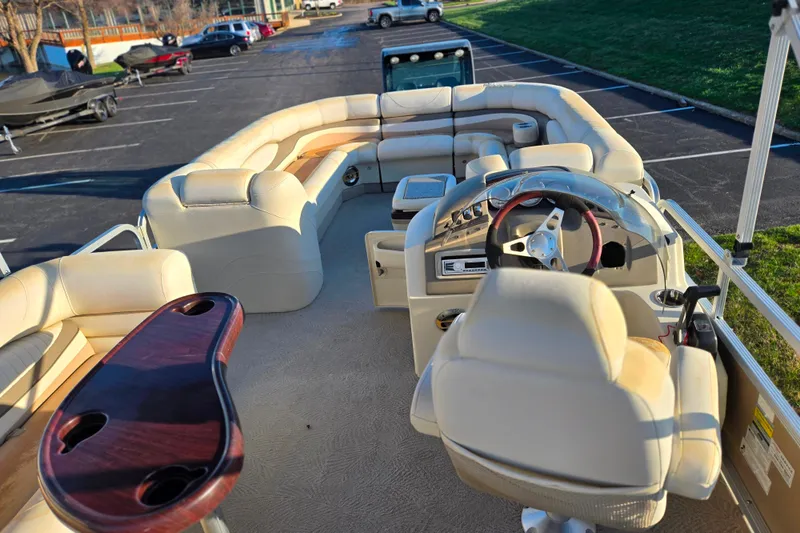 Slide: The Image of 2008 Bennington 2275RL pontoon boat interior with plush seating and steering console. - 22