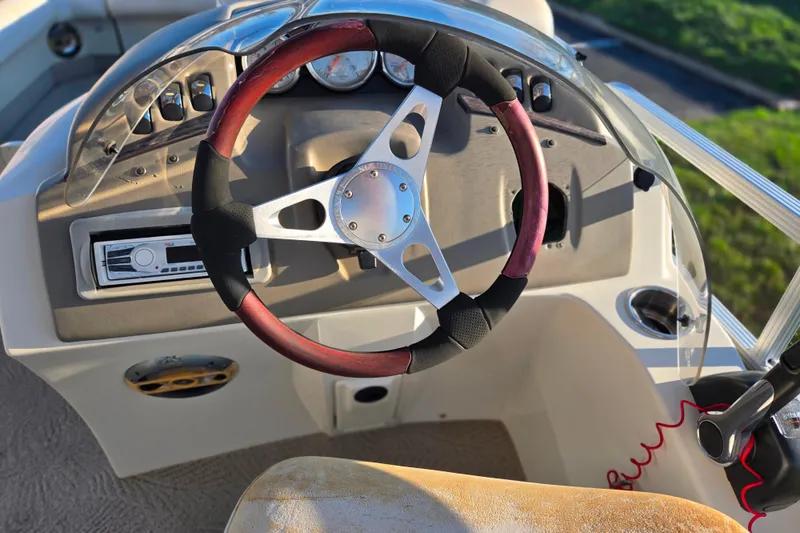 Slide: The Image of Steering wheel and dashboard of a 2008 Bennington 2275RL boat. - 23
