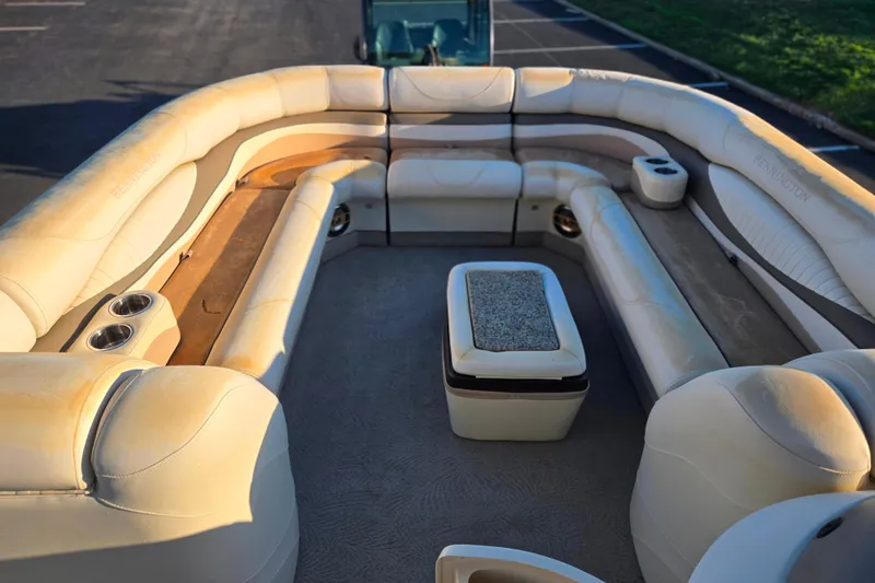 Slide: The Image of 2008 Bennington 2275RL boat interior with beige seating and cup holders. - 24