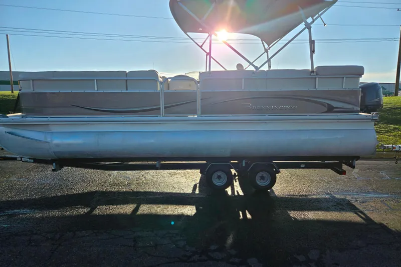 Slide: The Image of 2008 Bennington 2275RL pontoon boat on trailer, sunlit background. - 4