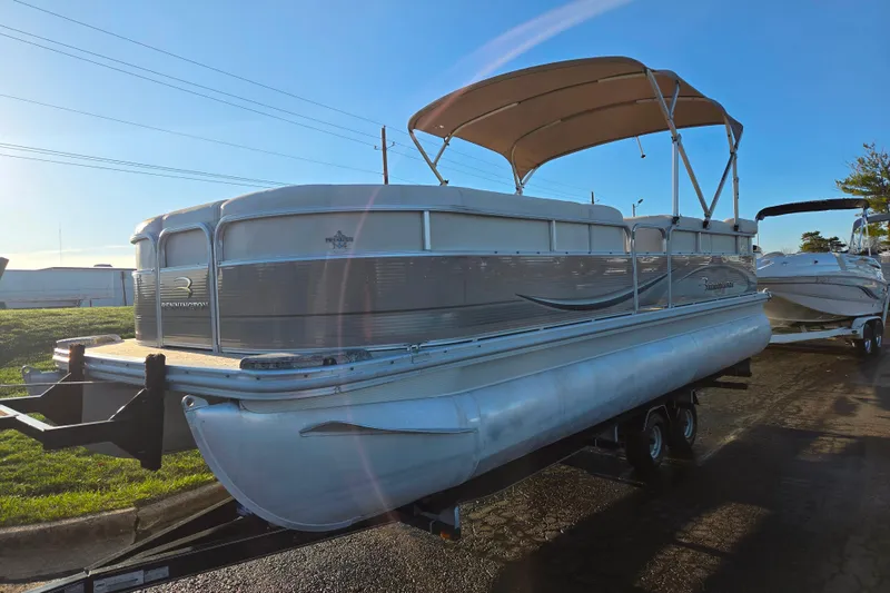Slide: The Image of 2008 Bennington 2275RL pontoon boat on trailer under clear blue sky. - 5