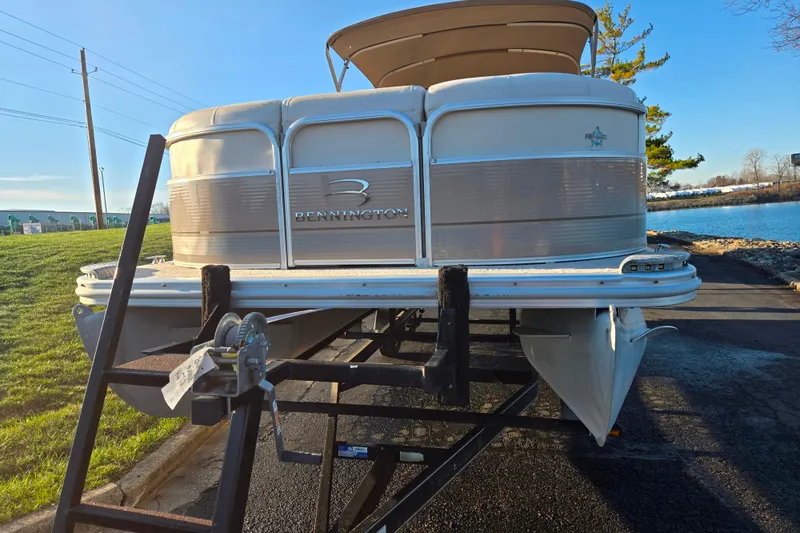Slide: The Image of 2008 Bennington 2275RL pontoon boat on trailer by a lakeside. - 6