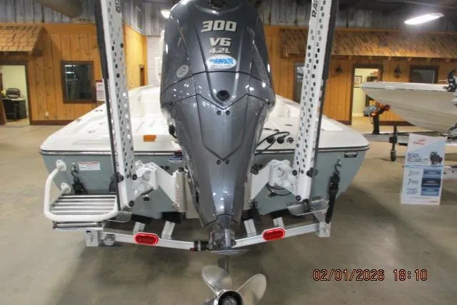 Slide: The Image of 2025 Skeeter SX241 boat with 300 V6 engine displayed indoors. - 2
