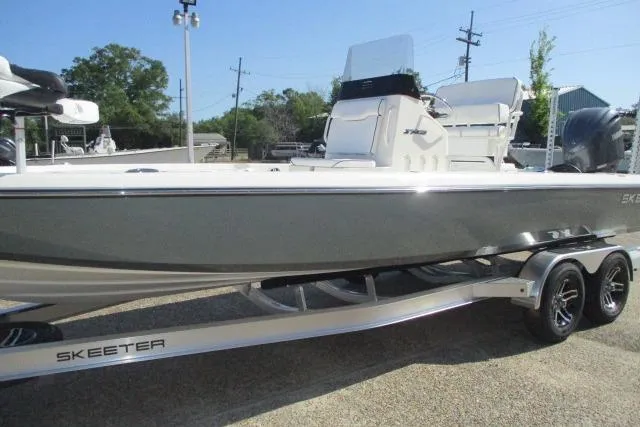 Slide: The Image of 2025 Skeeter SX241 boat on trailer, side view, outdoors. - 8