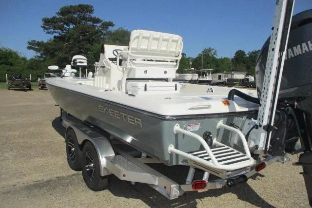 Slide: The Image of 2025 Skeeter SX241 boat on trailer, featuring Yamaha engine, parked outdoors. - 9