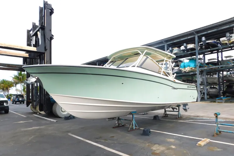 The Image of 2015 Grady-White Freedom 307 boat on stands in a marina storage area. - 0