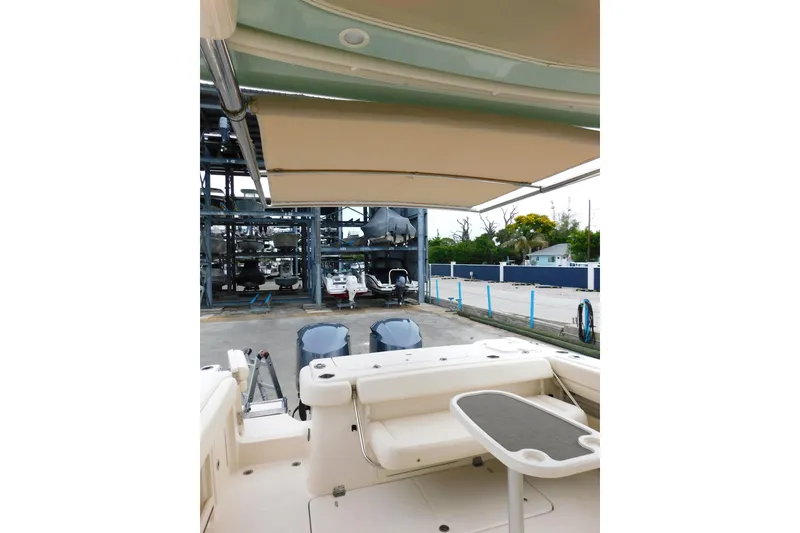 Slide: The Image of 2015 Grady-White Freedom 307 boat interior with seating and table, docked at marina. - 10