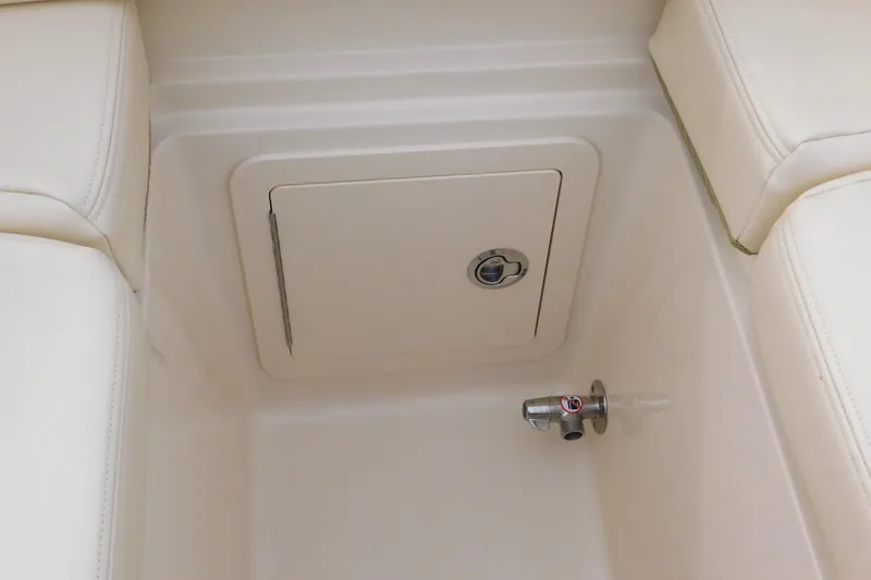 Slide: The Image of Storage compartment and valve on 2015 Grady-White Freedom 307 boat interior. - 12