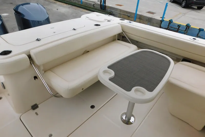 Slide: The Image of 2015 Grady-White Freedom 307 boat interior with seating and table setup. - 13