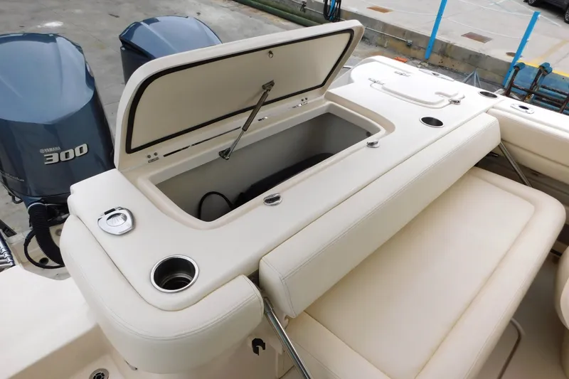Slide: The Image of 2015 Grady-White Freedom 307 boat with open storage compartment and Yamaha 300 engines. - 15