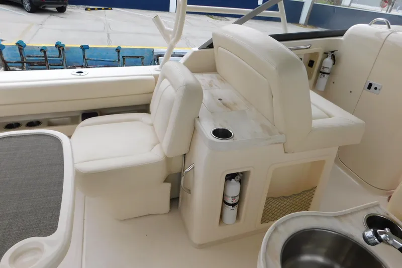 Slide: The Image of 2016 Grady-White Freedom 307 boat interior with seating and sink area. - 16