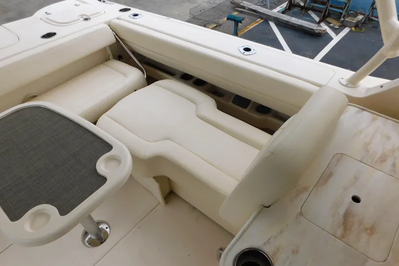Slide: The Image of 2015 Grady-White Freedom 307 boat interior with beige seating and table. - 18