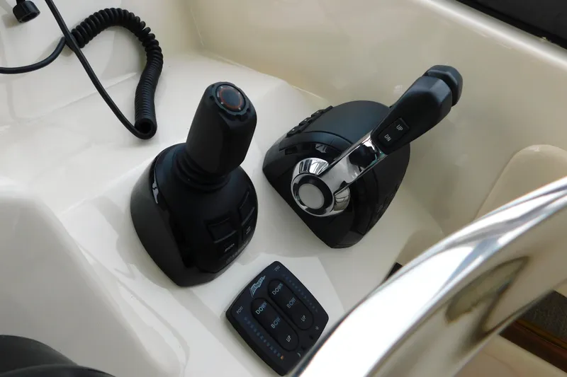 Slide: The Image of 2016 Grady-White Freedom 307 boat controls, featuring joystick and throttle levers. - 22
