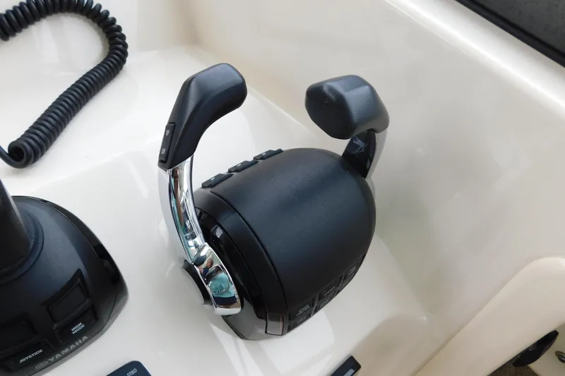 Slide: The Image of Close-up of throttle controls on a 2015 Grady-White Freedom 307 boat. - 23