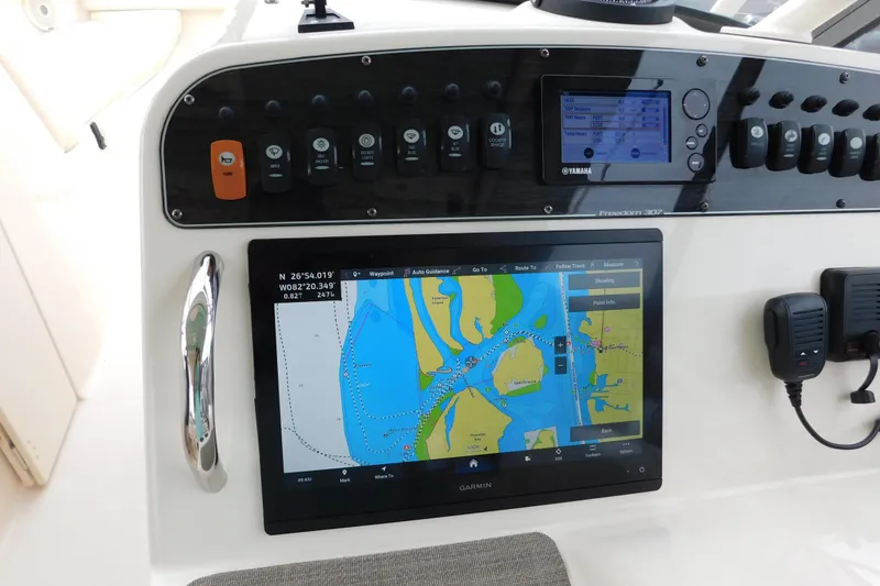 Slide: The Image of Control panel of 2015 Grady-White Freedom 307 boat with Garmin navigation display. - 25