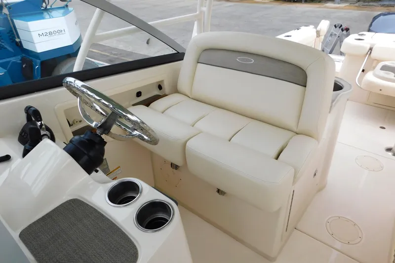 Slide: The Image of 2015 Grady-White Freedom 307 boat interior with steering wheel and seating area. - 29