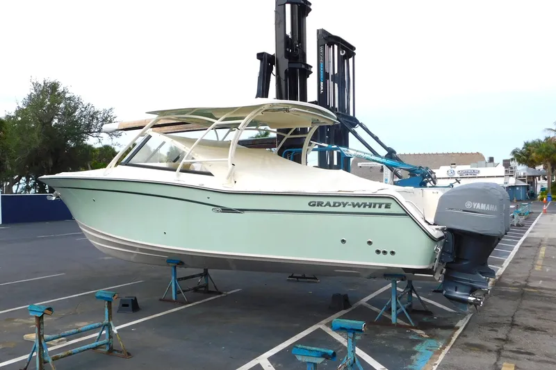 Slide: The Image of 2015 Grady-White Freedom 307 boat on stands, featuring Yamaha outboard motor. - 3