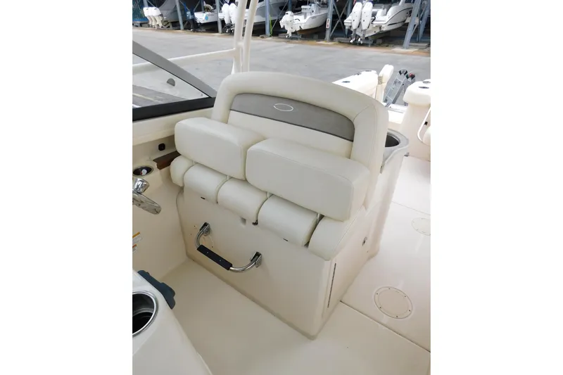 Slide: The Image of 2015 Grady-White Freedom 307 boat interior with cushioned seating and storage. - 30