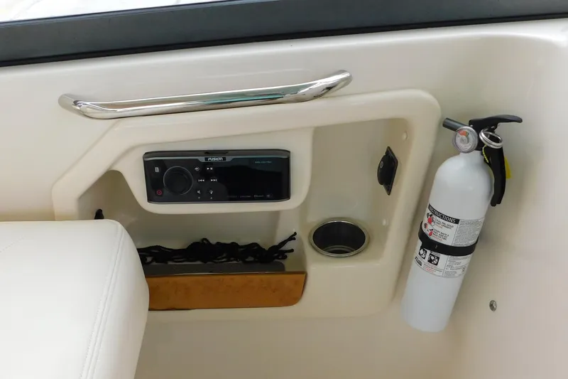Slide: The Image of 2015 Grady-White Freedom 307 boat interior with stereo, cup holder, and fire extinguisher. - 32