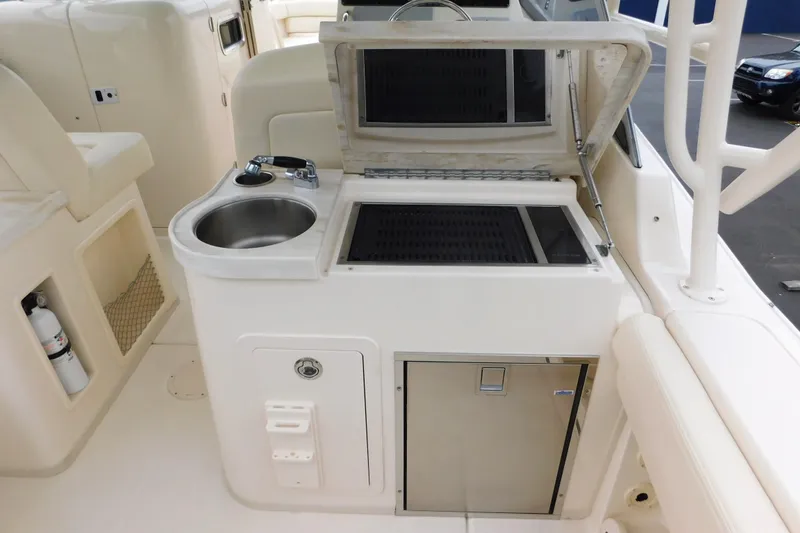 Slide: The Image of 2015 Grady-White Freedom 307 boat interior with sink and grill station. - 33