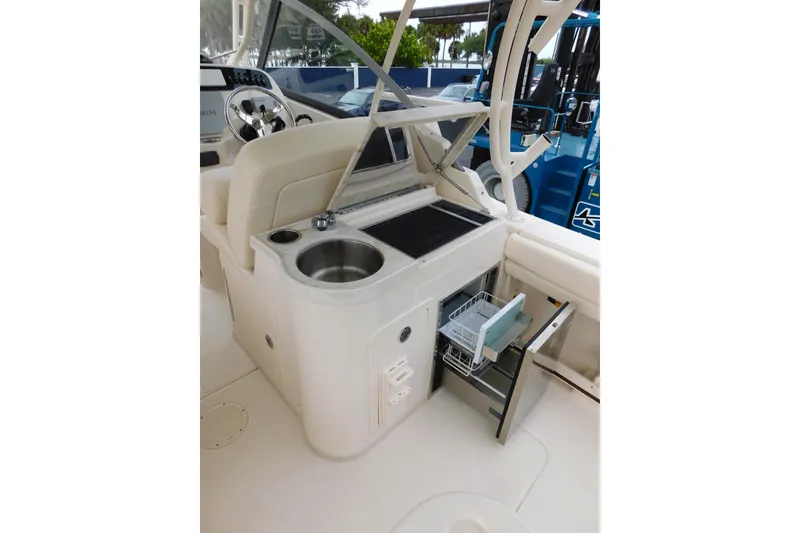 Slide: The Image of 2016 Grady-White Freedom 307 boat interior with sink and storage compartments. - 34