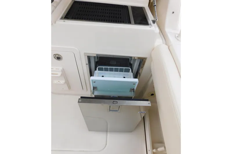 Slide: The Image of 2016 Grady-White Freedom 307 boat interior with open storage compartment. - 35