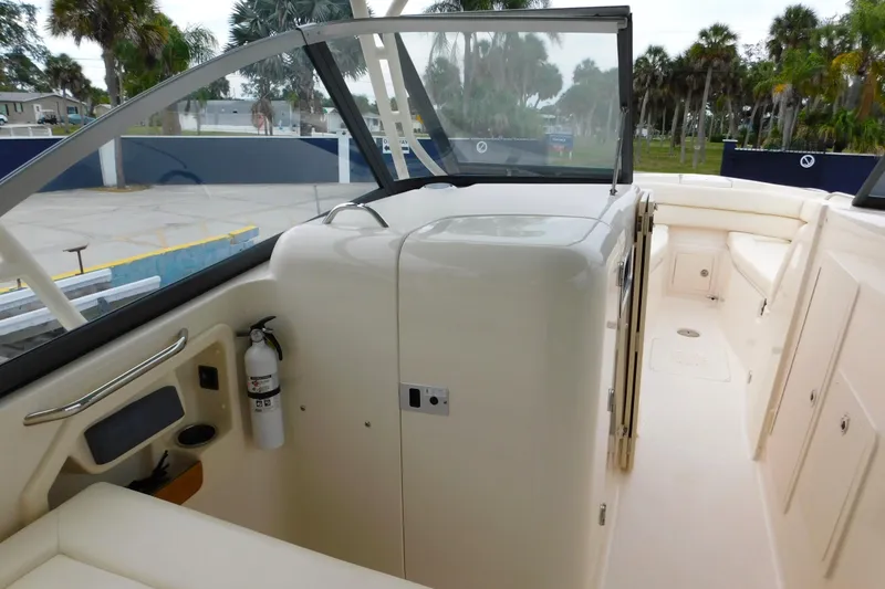 Slide: The Image of 2015 Grady-White Freedom 307 boat interior with seating and storage compartments. - 38