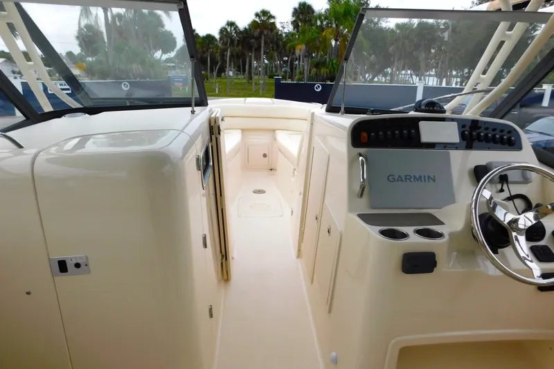 Slide: The Image of 2015 Grady-White Freedom 307 boat interior with Garmin navigation system and steering wheel. - 39