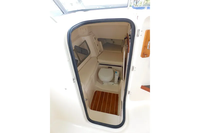 Slide: The Image of Interior view of 2015 Grady-White Freedom 307 boat cabin with toilet and seating area. - 40