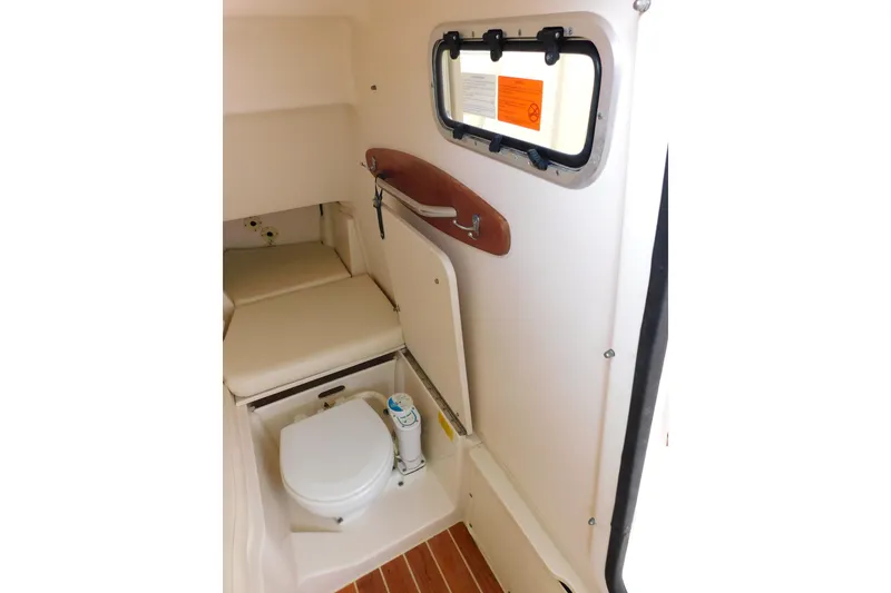 Slide: The Image of 2015 Grady-White Freedom 307 boat interior with compact marine toilet and window. - 42