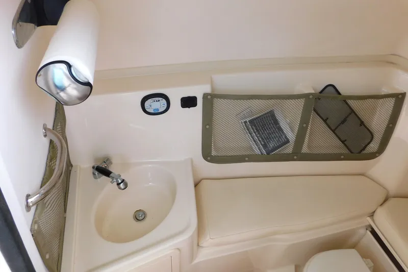 Slide: The Image of 2015 Grady-White Freedom 307 boat interior with sink and storage compartments. - 44