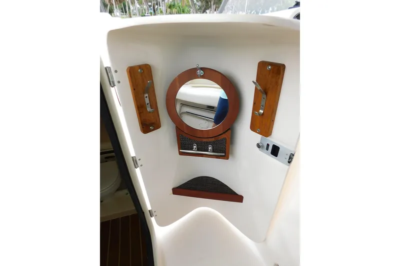 Slide: The Image of Interior of 2015 Grady-White Freedom 307 boat with mirror and wooden accents. - 45