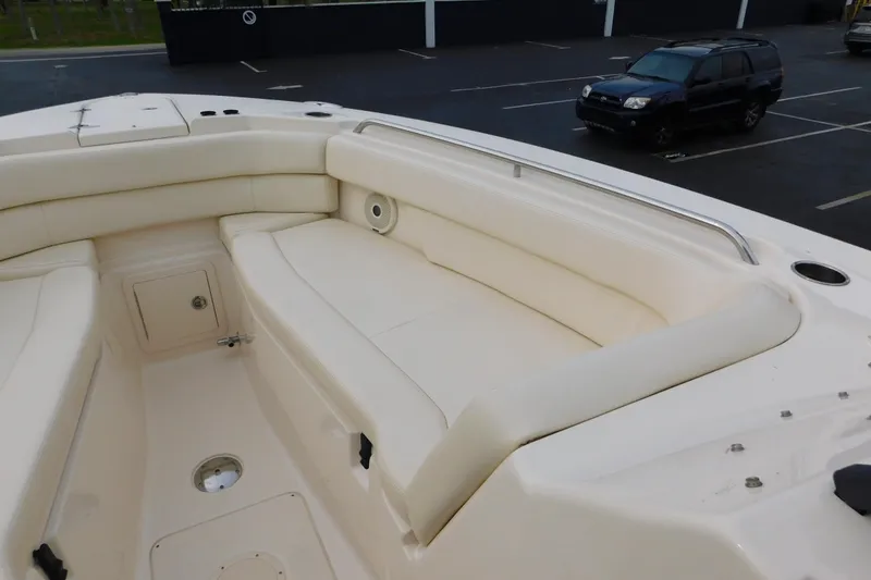 Slide: The Image of 2016 Grady-White Freedom 307 boat interior with cushioned seating and storage compartments. - 48
