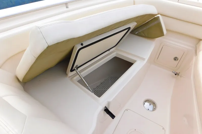 Slide: The Image of 2016 Grady-White Freedom 307 boat interior storage compartment with cushioned seating. - 50