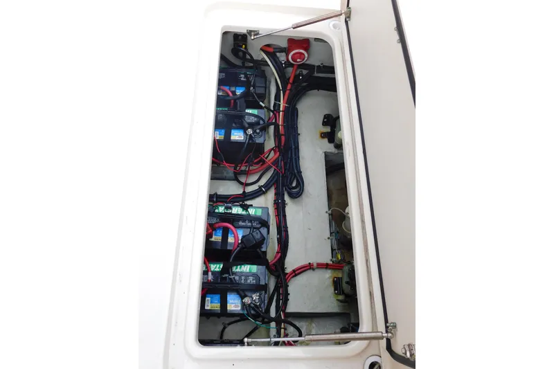 Slide: The Image of Battery compartment of 2015 Grady-White Freedom 307 boat, showcasing wiring and connections. - 52