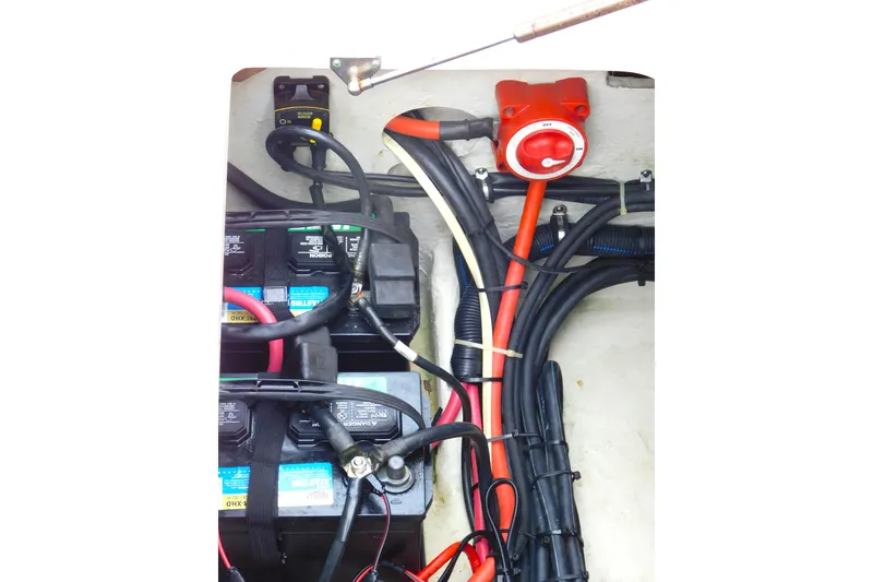 Slide: The Image of Electrical wiring and battery setup in a 2015 Grady-White Freedom 307 boat. - 54