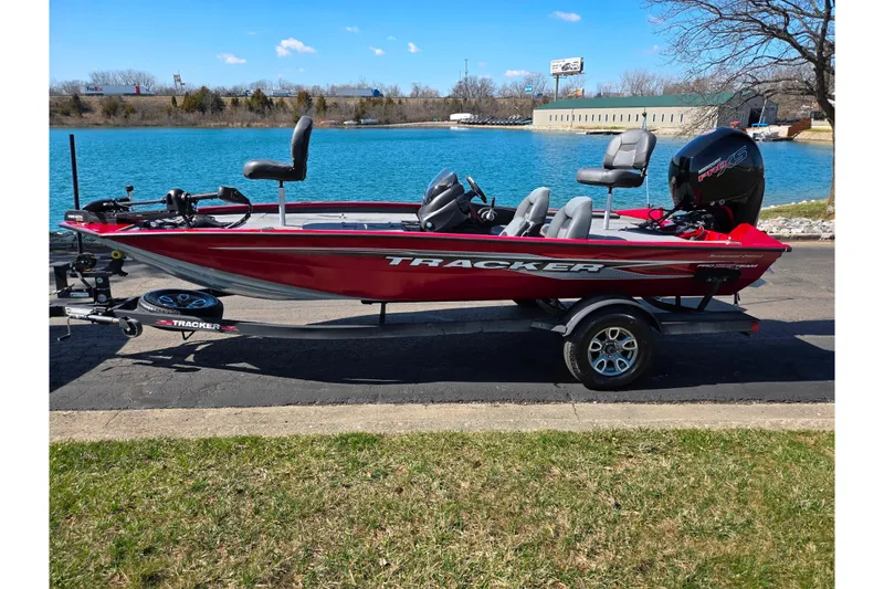 Slide: The Image of 2024 Tracker Pro Team 195 TXW Tournament Edition boat by a lake. - 10