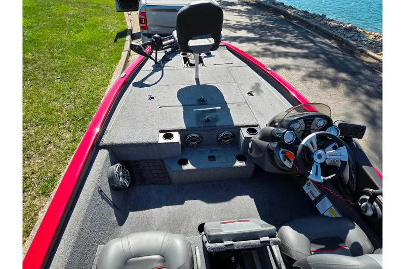 Slide: The Image of 2024 Tracker Pro Team 195 TXW Tournament Edition boat interior with steering console and seating. - 11