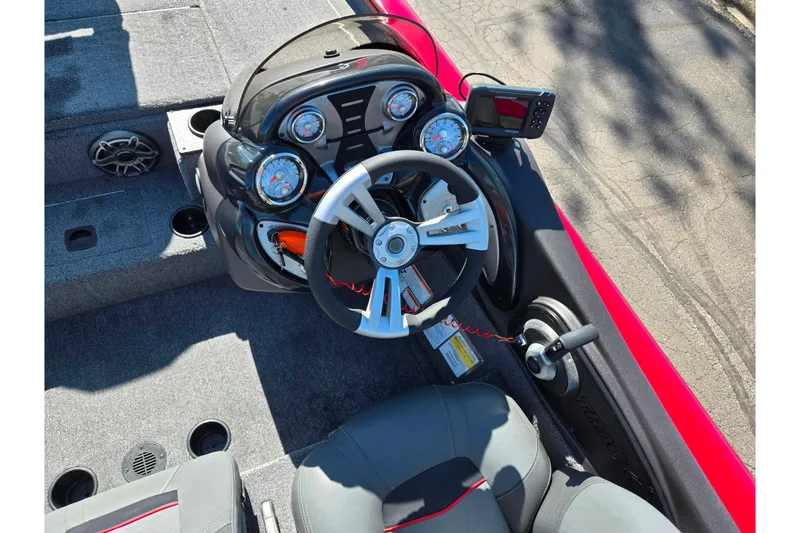 Slide: The Image of 2024 Tracker Pro Team 195 TXW Tournament Edition boat dashboard with steering wheel and gauges. - 12