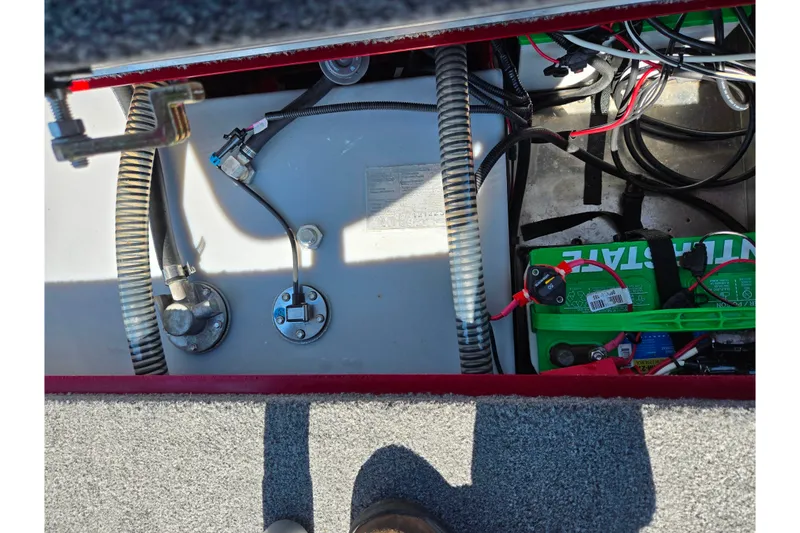 Slide: The Image of 2024 Tracker Pro Team 195 TXW Tournament Edition boat battery compartment with wiring and components. - 23