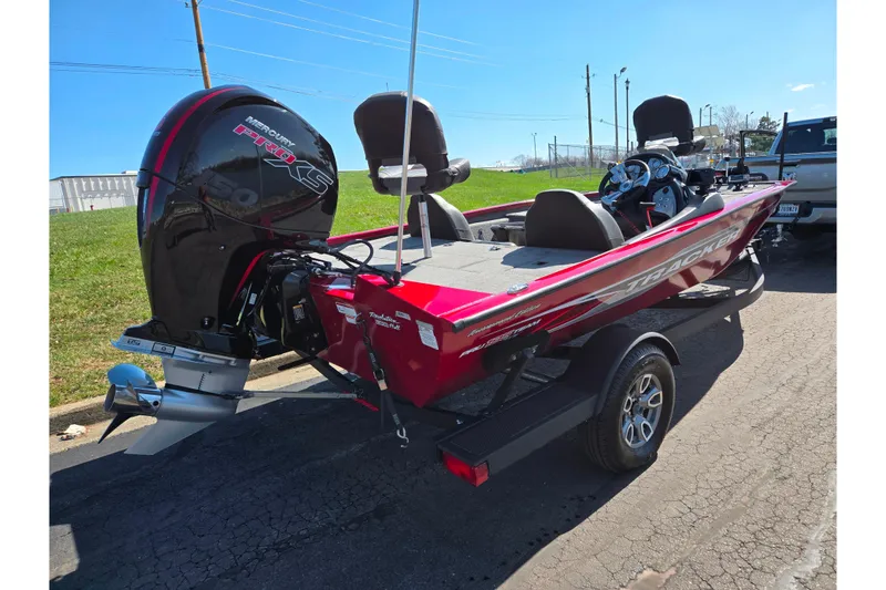 Slide: The Image of 2024 Tracker Pro Team 195 TXW Tournament Edition boat with Mercury engine, parked outdoors. - 3