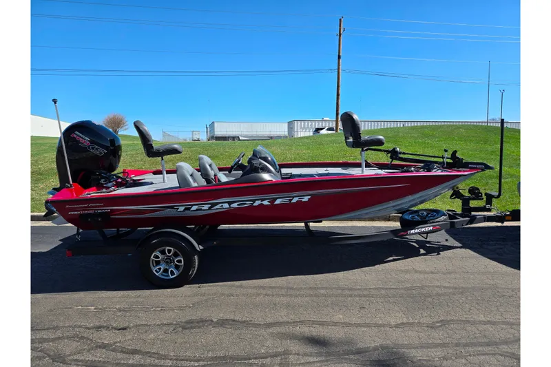 Slide: The Image of 2024 Tracker Pro Team 195 TXW Tournament Edition boat on trailer, red exterior. - 4