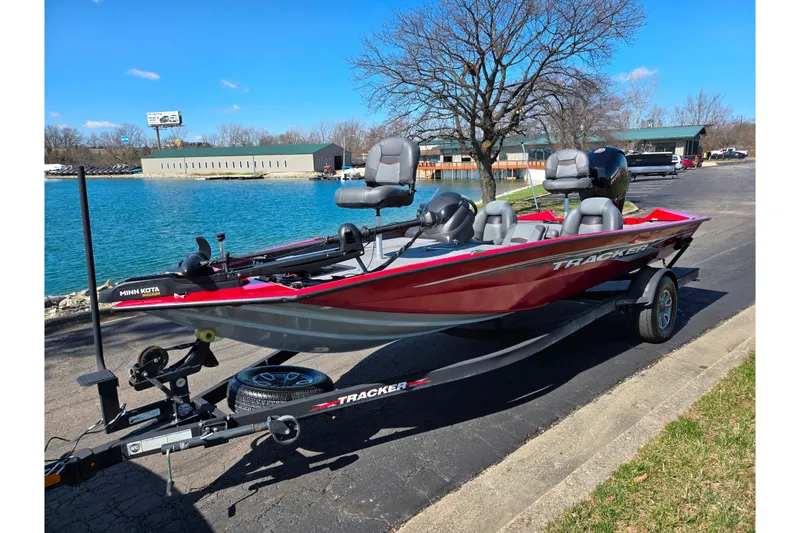 Slide: The Image of 2024 Tracker Pro Team 195 TXW Tournament Edition boat on trailer by a lake. - 9