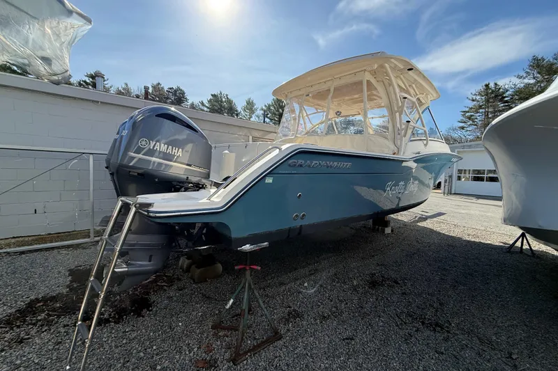Slide: The Image of 2020 Grady-White Freedom 325 boat with Yamaha engine, parked outdoors on gravel. - 11