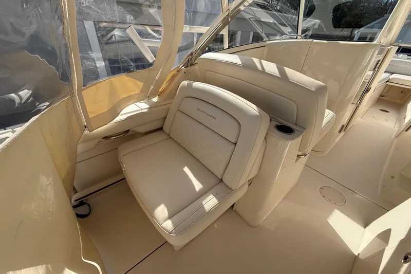 Slide: The Image of 2020 Grady-White Freedom 325 boat interior with beige seating and cup holder. - 15