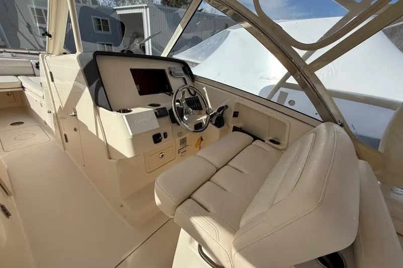 Slide: The Image of 2020 Grady-White Freedom 325 boat interior with steering wheel and seating. - 16