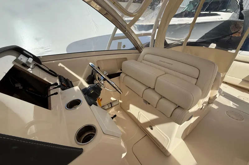 Slide: The Image of 2020 Grady-White Freedom 325 boat interior with helm and seating area. - 17
